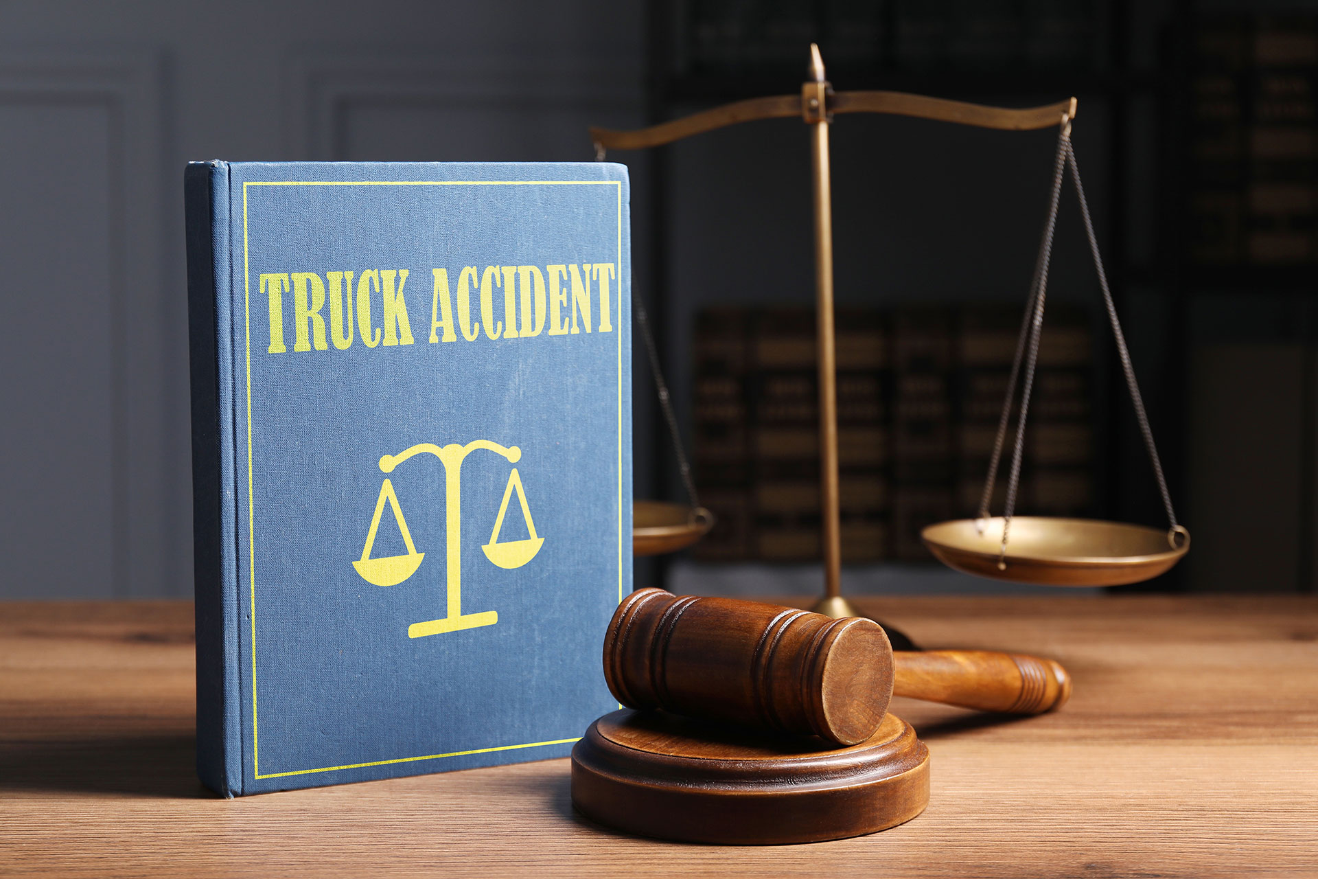 Truck accident book with scale and wooden gavel