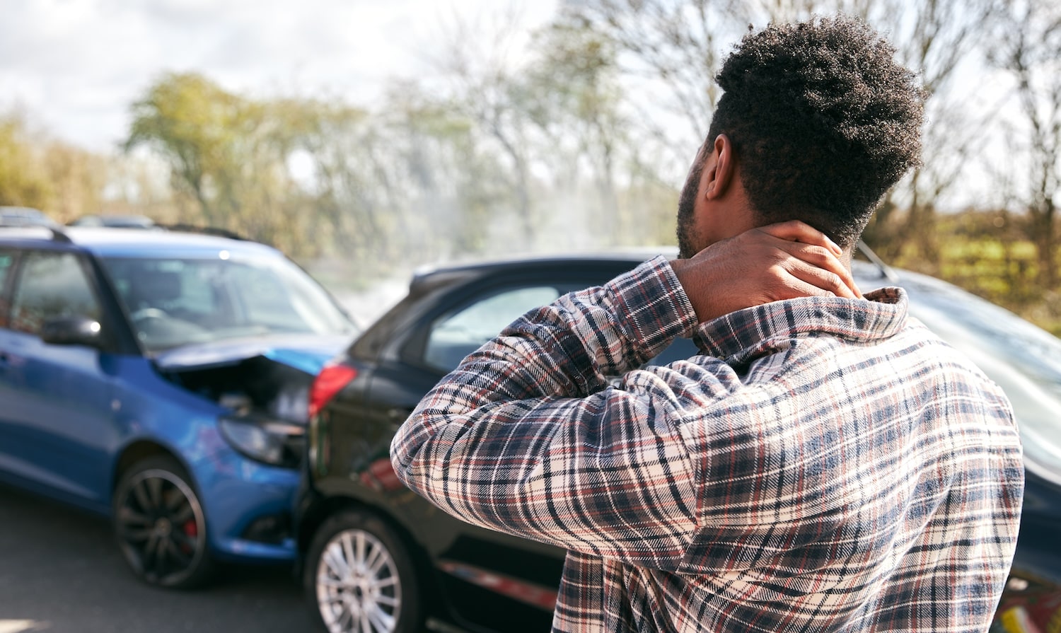 Man holding neck after car accident