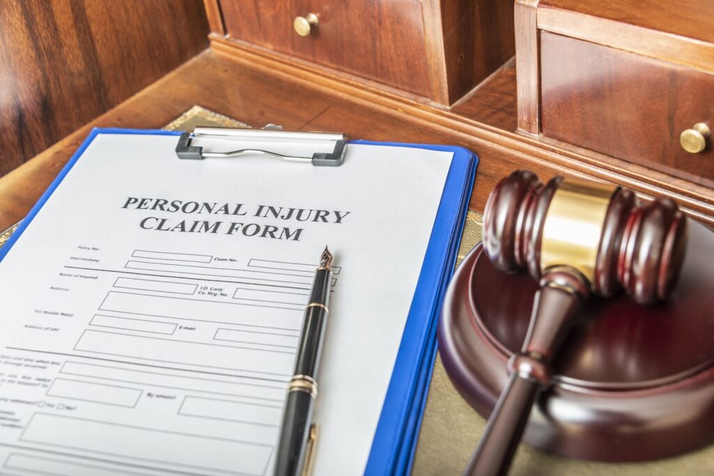 Clipboard with personal injury claim form and gavel