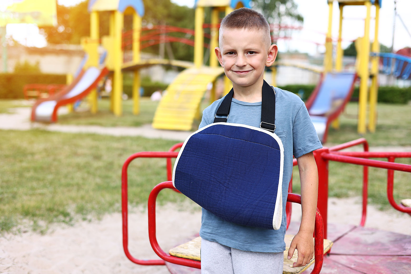 Child on playground with arm sling