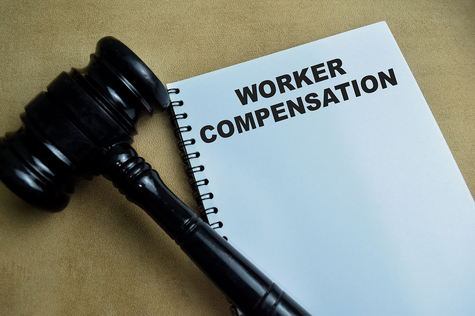 Workers compensation written on notepad and gavel